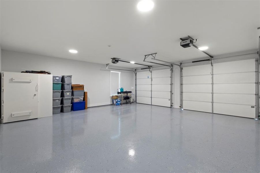 Oversized fully insulated 26x26 garage featuring 10x8 garage doors with very quiet linear operators, sleek finished floors, abundant lighting, and an EF-5 rated tornado pod—offering secure, functional space with added peace of mind.