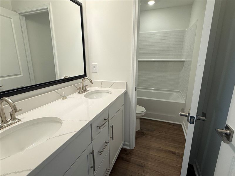 A well-appointed bath features dual vanities and s A well-appointed bath features dual vanities and s
