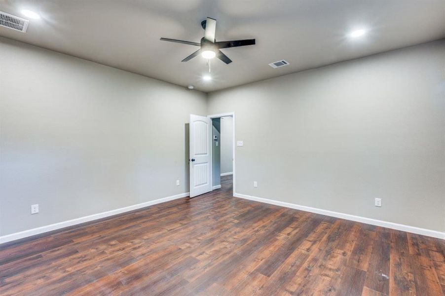 Spare room with ceiling fan and dark hardwood / wood-style floors