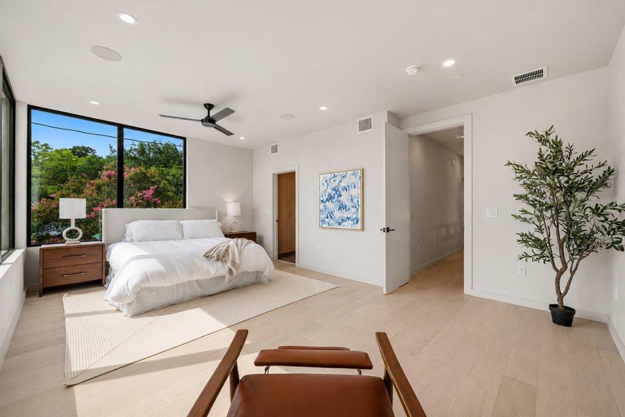 Natural light pours into this tranquil bedroom, showcasing the sleek hardwood floors. Natural light pours into this tranquil bedroom, showcasing the sleek hardwood floors.