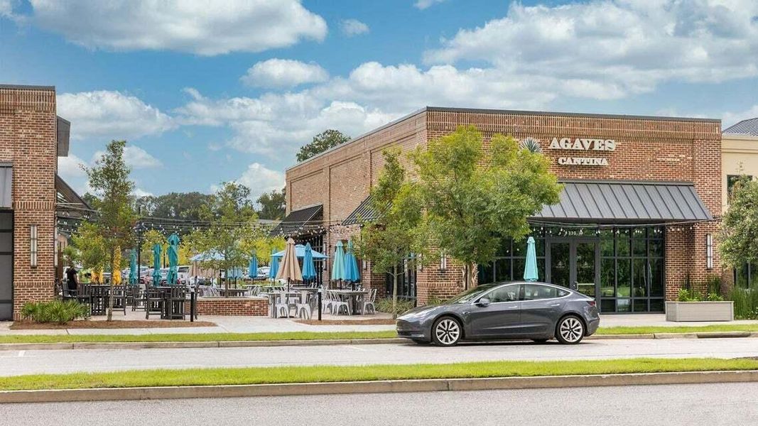 Front exterior of a new home in Ashley Walk Townes, Charleston, SC, highlighting curb appeal (Image 2). Front exterior of a new home in Ashley Walk Townes, Charleston, SC, highlighting curb appeal (Image 2).