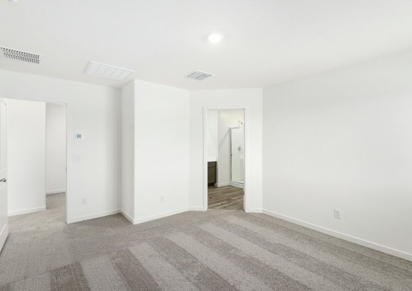 The master bedroom seamlessly connects to the luxurious bathroom.