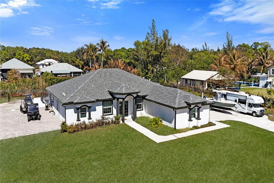 Front exterior of a new home in , Loxahatchee, FL, highlighting curb appeal (Image 31).