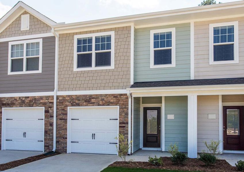 The two-story Bradford B elevation with stone detailing and an attached garage.