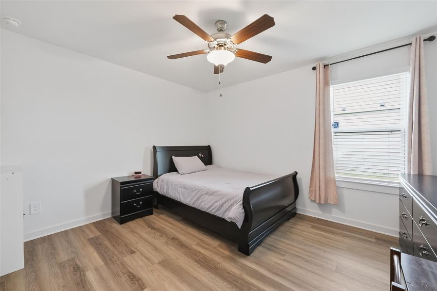Secondary bedroom #1 featuring a walk-in closet for added storage