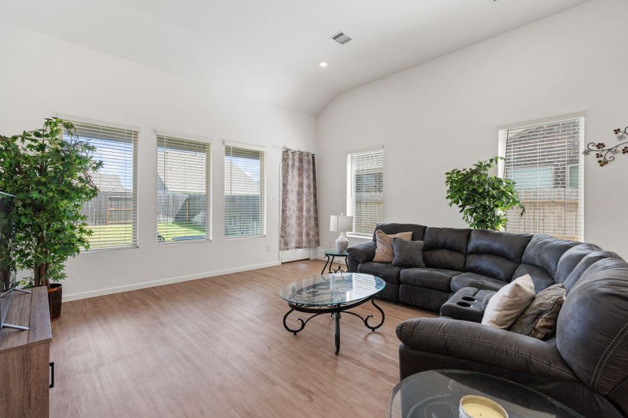This large living room features high ceilings and is full of beautiful natural light!
