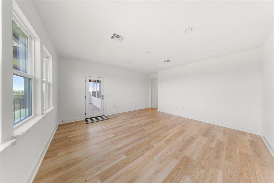 Spare room with light wood-style flooring and baseboards Spare room with light wood-style flooring and baseboards