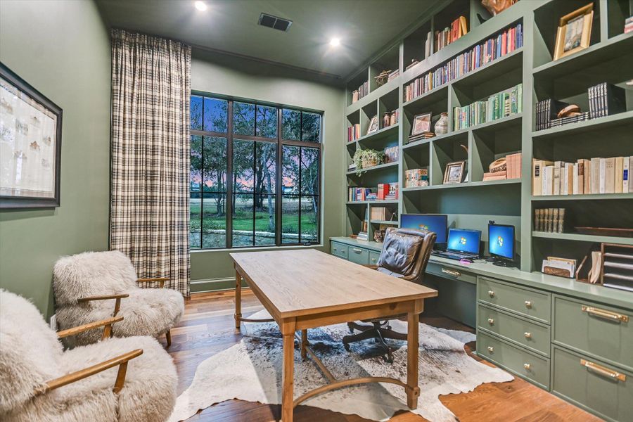 Office area featuring light wood finished floors and built in study area Office area featuring light wood finished floors and built in study area