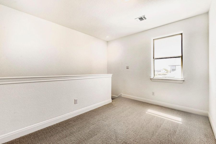 Carpeted empty room with baseboards Carpeted empty room with baseboards