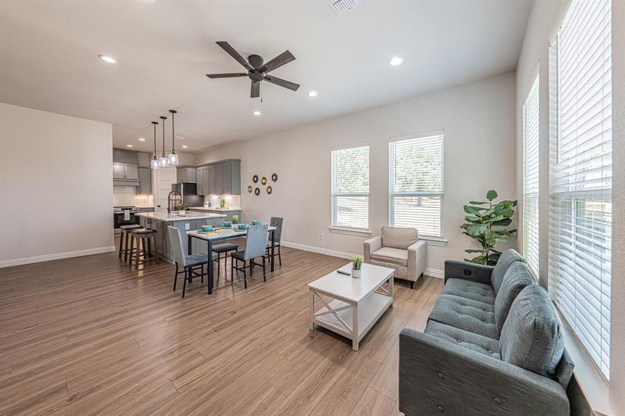 Living room with recessed lighting, a ceiling fan, and light wood-type flooring Living room with recessed lighting, a ceiling fan, and light wood-type flooring