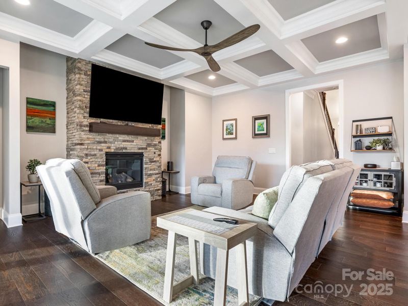 1st Flr, Great Room w/coffered ceiling, recessed lighting, ceiling fan, a stone gas burning fire place complete with a blower (17x19)