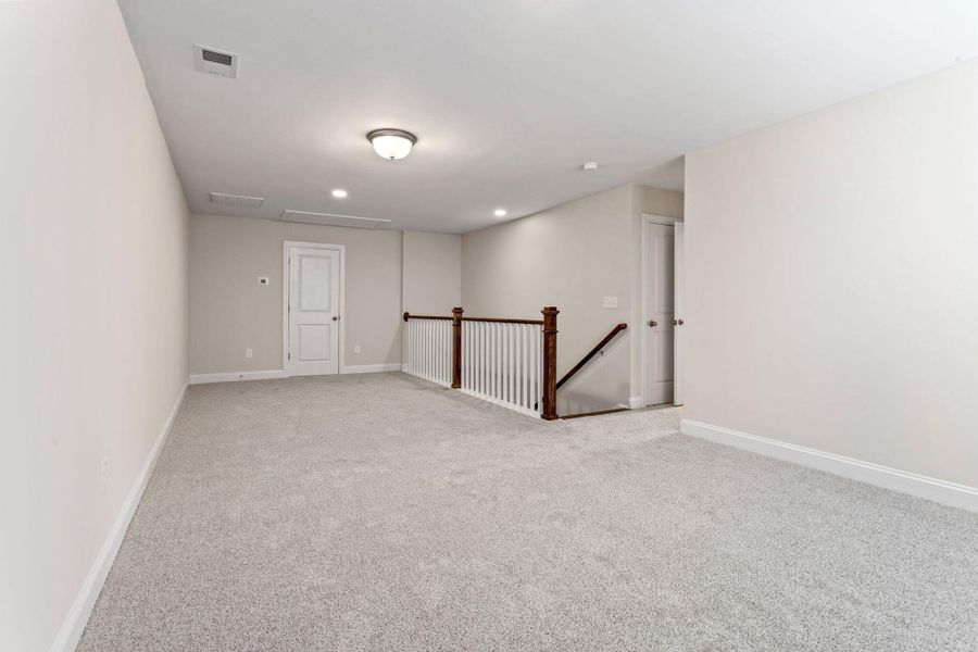 Spacious, unfurnished interior of a new home in Tidewater at Lakes of Cane Bay, Summerville (Image 13).