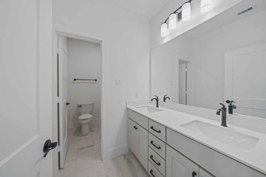 Representative furnished interior of a home built from the Waterloo by Chesmar Homes in Attwater 65's, Waller (Image 9).