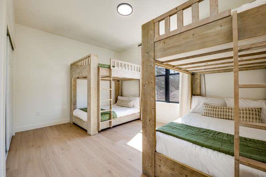 Unfurnished bedroom featuring wood finished floors and a closet