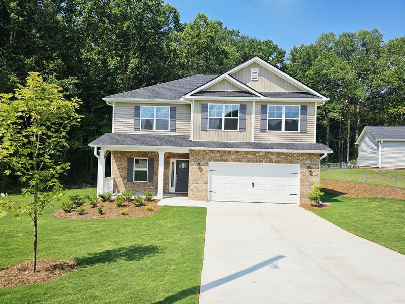 Front exterior of a new home in Scarlett Place, Bowdon, GA, highlighting curb appeal (Image 1).