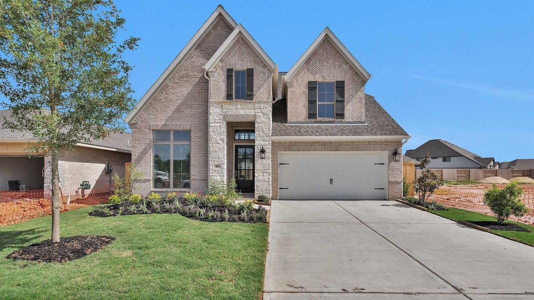 Front exterior of a new home in Candela South 50', Richmond, TX, highlighting curb appeal (Image 1). Front exterior of a new home in Candela South 50', Richmond, TX, highlighting curb appeal (Image 1).