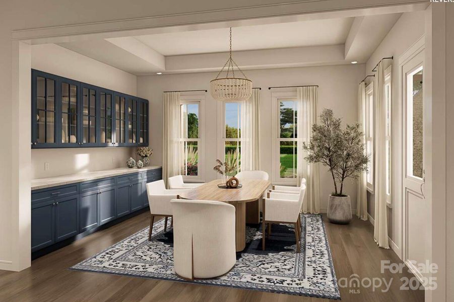 This elegant dining room offers a perfect balance of sophistication and warmth. The space features full-height navy built-in cabinetry with glass-front upper doors. This elegant dining room offers a perfect balance of sophistication and warmth. The space features full-height navy built-in cabinetry with glass-front upper doors.