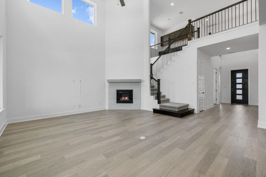 Family Room with soaring ceiling & fireplace