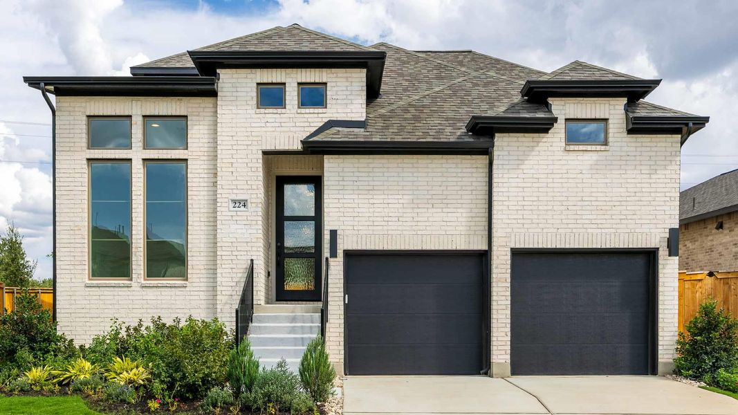 View of front of house featuring a shingled roof, brick siding, and concrete driveway View of front of house featuring a shingled roof, brick siding, and concrete driveway