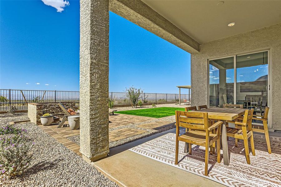 Fenced backyard with a patio area and outdoor dining area
