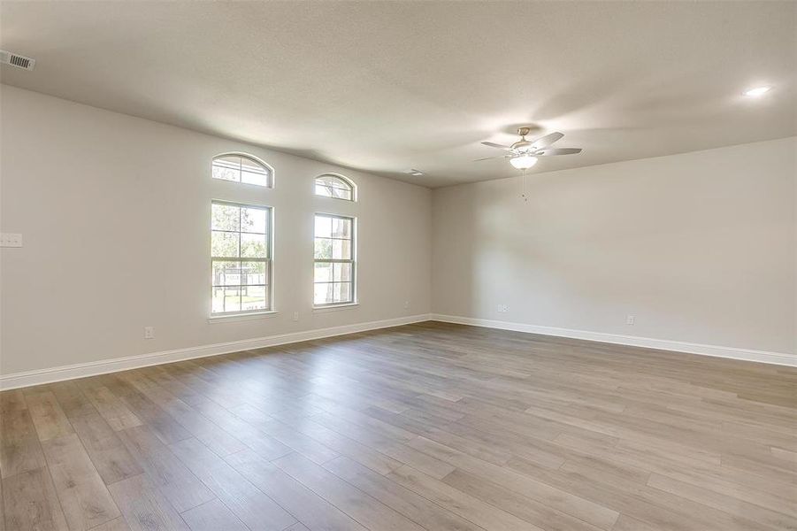 Spare room with light wood-type flooring and ceiling fan Spare room with light wood-type flooring and ceiling fan