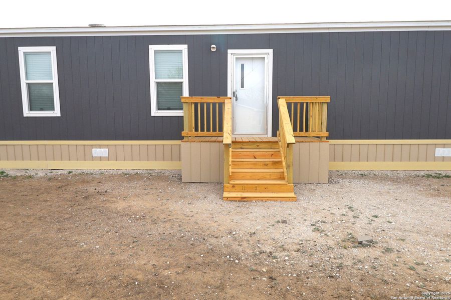 Front exterior of a new home in , Poteet, TX, highlighting curb appeal (Image 1).