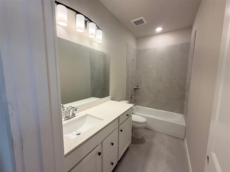 Secondary bathroom has additional cabinets for all your presonal needs.