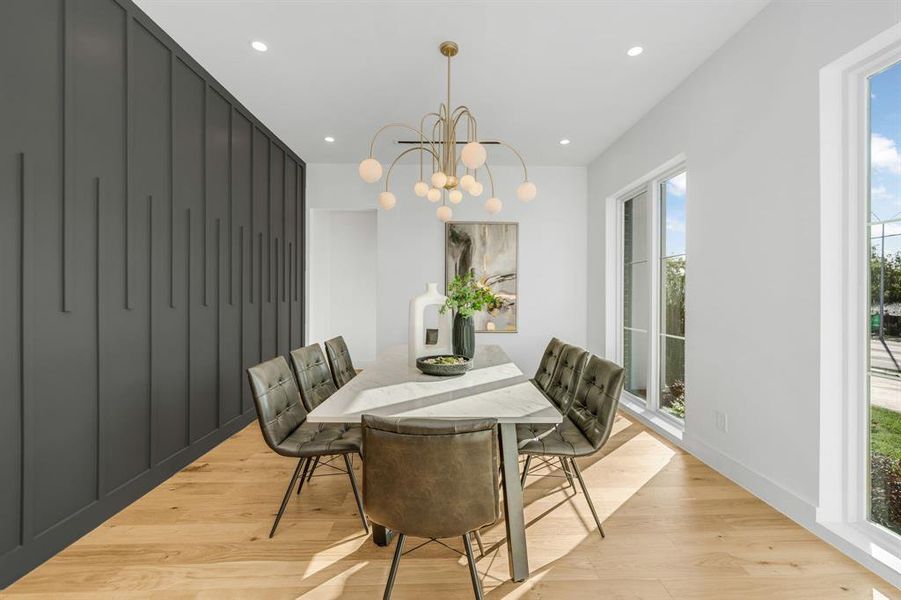 Dining room with recessed lighting, light wood finished floors, and a chandelier
