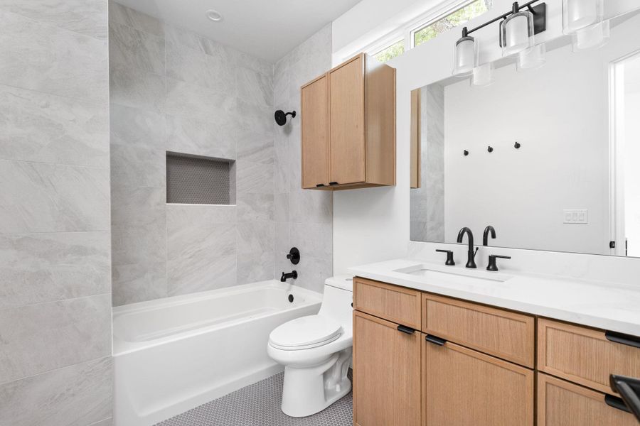Bathroom featuring vanity, shower / bathtub combination, and tile patterned flooring Bathroom featuring vanity, shower / bathtub combination, and tile patterned flooring