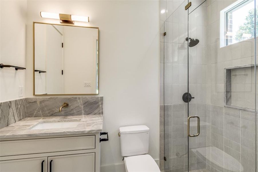 Bathroom featuring vanity, a stall shower, and tasteful backsplash Bathroom featuring vanity, a stall shower, and tasteful backsplash