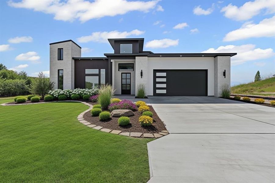 Modern home with a front lawn, concrete driveway, a garage, and stucco siding
