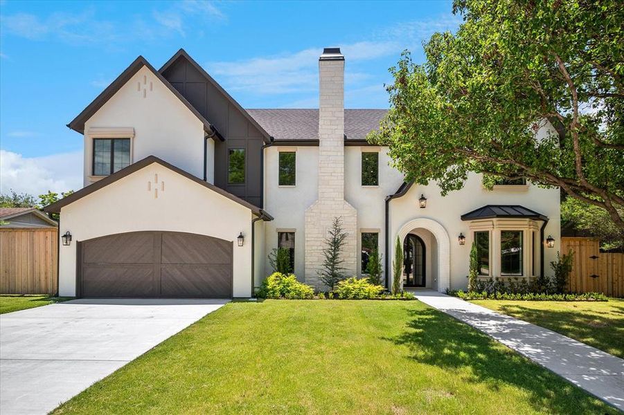 Front elevation, stone chimney, bay window, black standing seam metal roof accent Front elevation, stone chimney, bay window, black standing seam metal roof accent