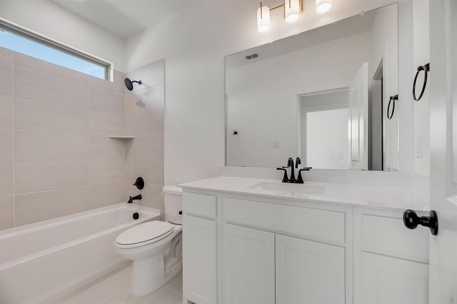 Bathroom with bathtub / shower combination, vanity, and light tile patterned flooring Bathroom with bathtub / shower combination, vanity, and light tile patterned flooring