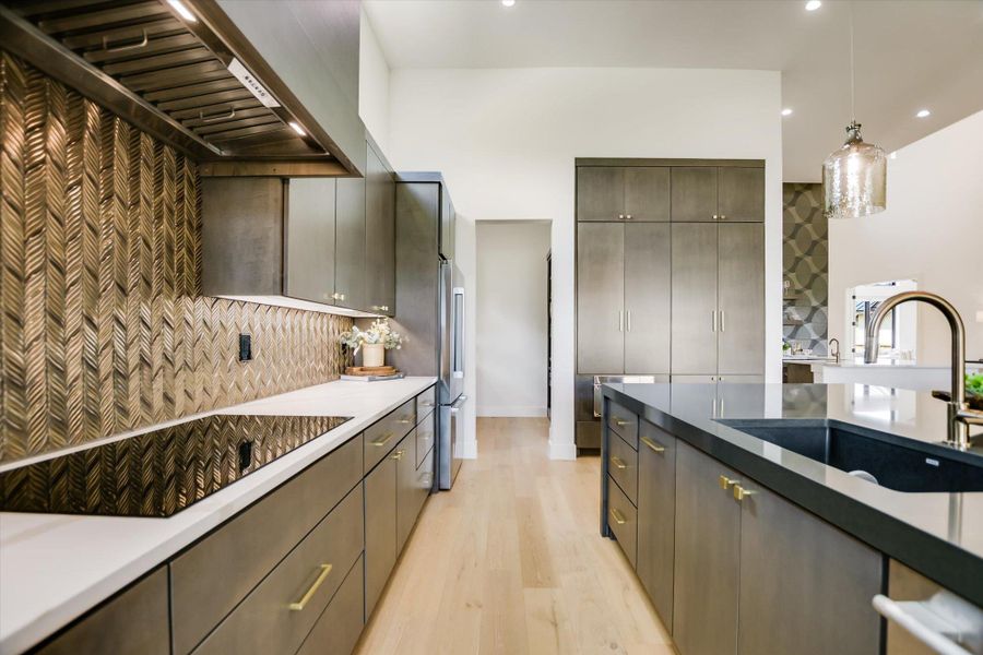 Culinary delights await in this modern kitchen with sleek cabinetry and an inviting island.