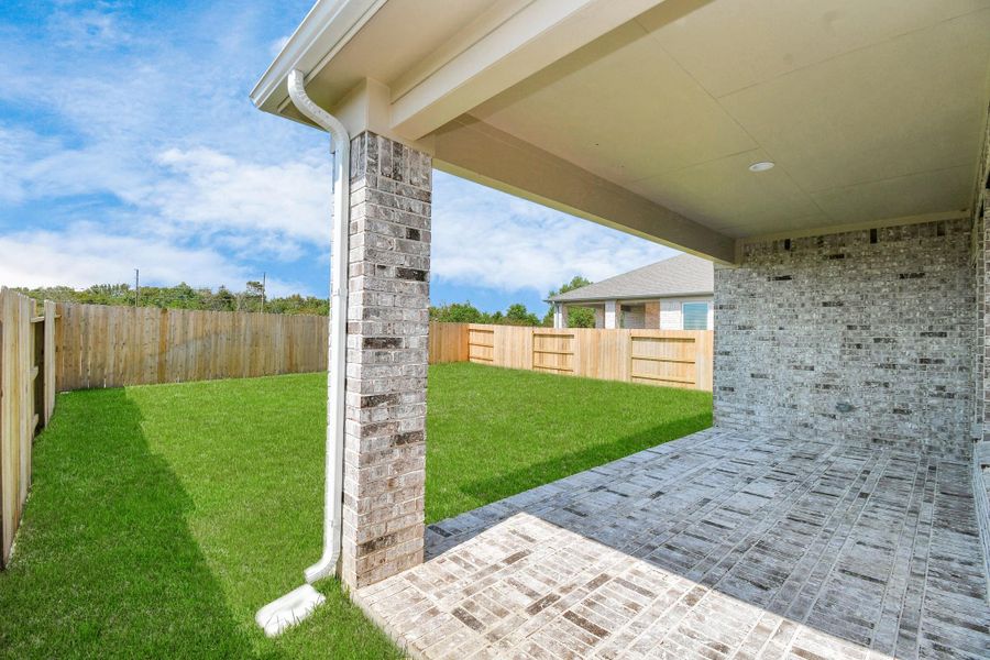 Experience outdoor living at its finest on this expansive covered patio, thoughtfully designed for BBQs and delightful outdoor dining