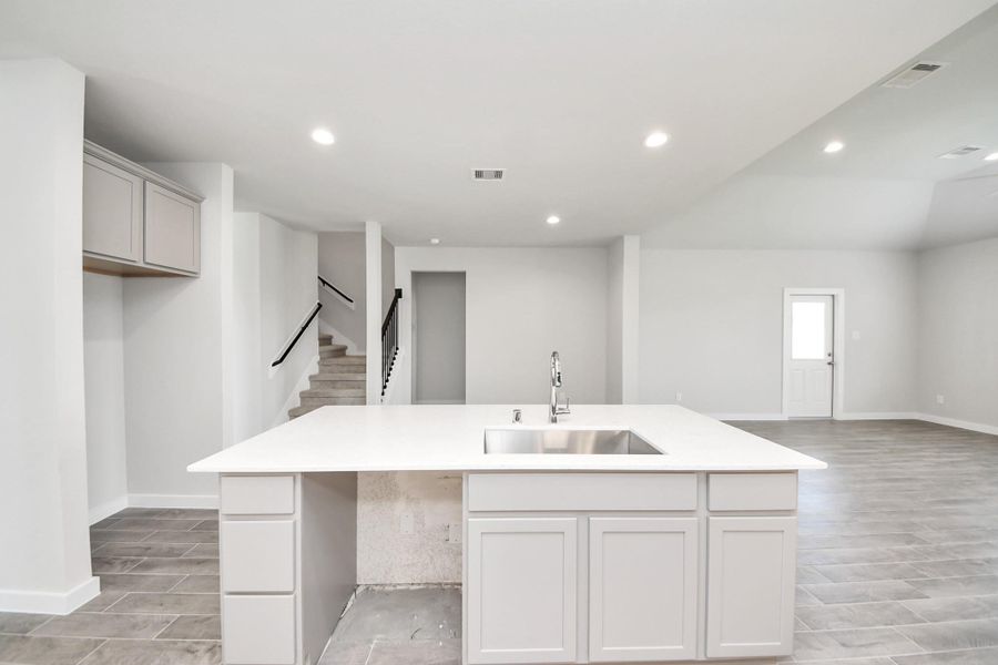 Discover another perspective of this stunning kitchen, generously appointed with an abundance of counter space. Discover another perspective of this stunning kitchen, generously appointed with an abundance of counter space.
