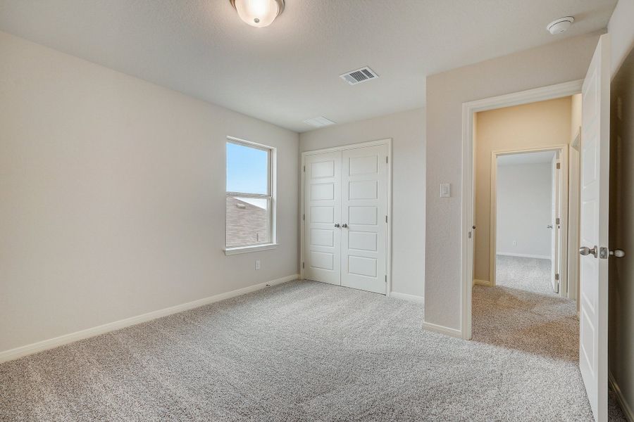 Guest bedroom in the Pearl floorplan at a Meritage Homes community.