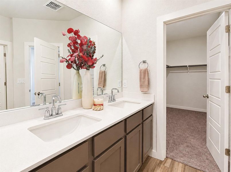 An adjacent walk-in closet sits just steps away from this dual vanity bathroom. An adjacent walk-in closet sits just steps away from this dual vanity bathroom.