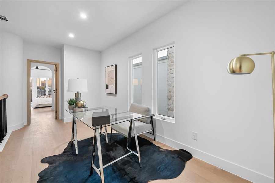 Office area with light wood-type flooring and recessed lighting