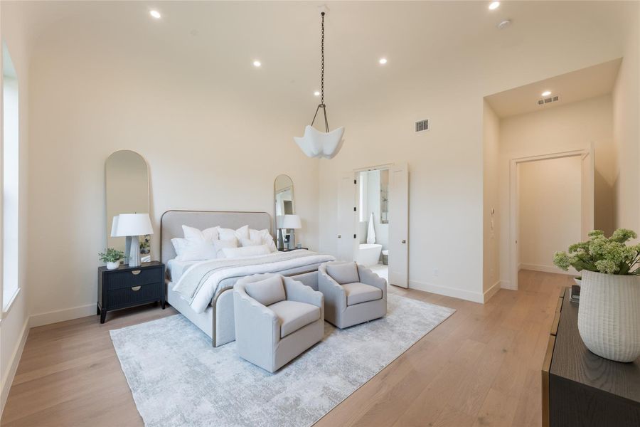 The primary bedroom is a serene retreat wrapped in subtle luxury. Barrel ceilings create a sense of volume and calm, while soft natural light spills in through generously sized windows. European white oak floors add warmth and understated refinement underfoot.Through the double doors, a peek into the spa-like ensuite promises a daily escape, blending functionality with sophisticated design. The primary bedroom is a serene retreat wrapped in subtle luxury. Barrel ceilings create a sense of volume and calm, while soft natural light spills in through generously sized windows. European white oak floors add warmth and understated refinement underfoot.Through the double doors, a peek into the spa-like ensuite promises a daily escape, blending functionality with sophisticated design.