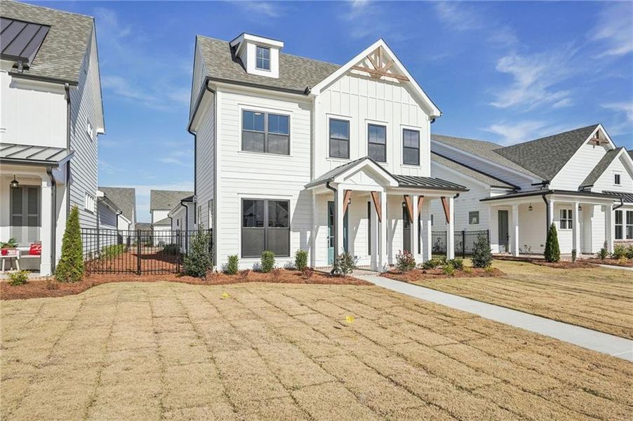 Front exterior of a new home in Promenade at Sawnee Village, Cumming, GA, highlighting curb appeal (Image 28). Front exterior of a new home in Promenade at Sawnee Village, Cumming, GA, highlighting curb appeal (Image 28).
