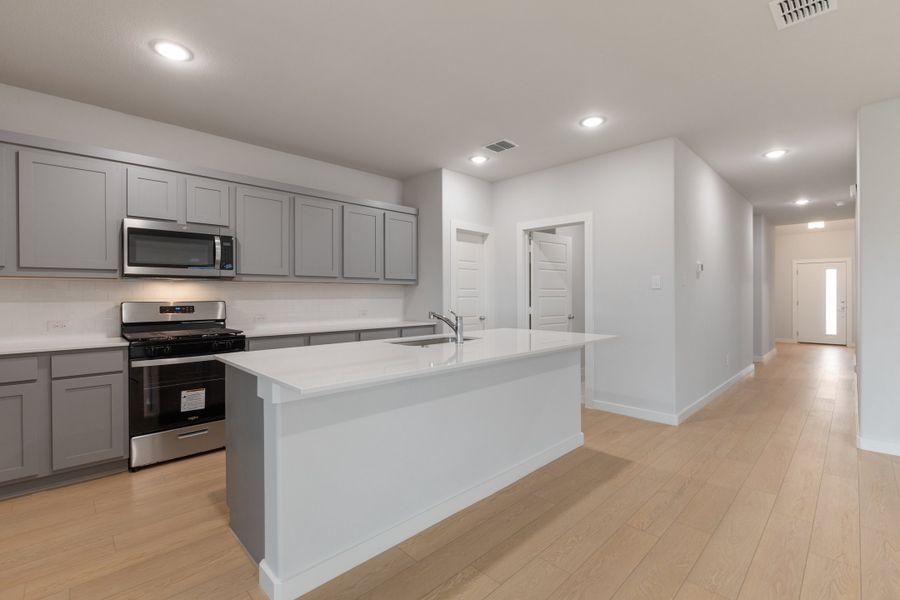 Kitchen in the Oscar home plan by Trophy Signature Homes – REPRESENTATIVE PHOTO