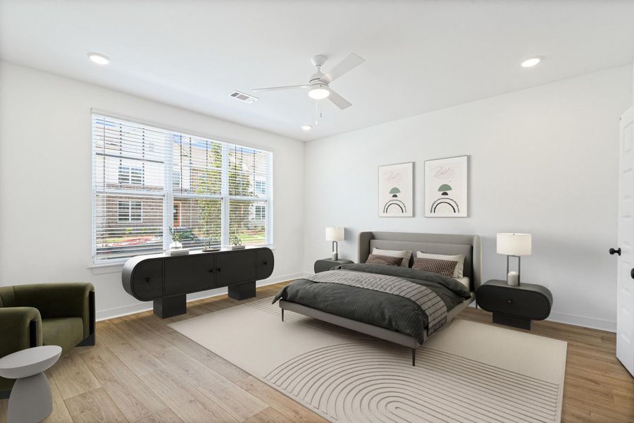 Spacious room featuring wood-finish flooring, recessed lighting, and a ceiling fan Spacious room featuring wood-finish flooring, recessed lighting, and a ceiling fan