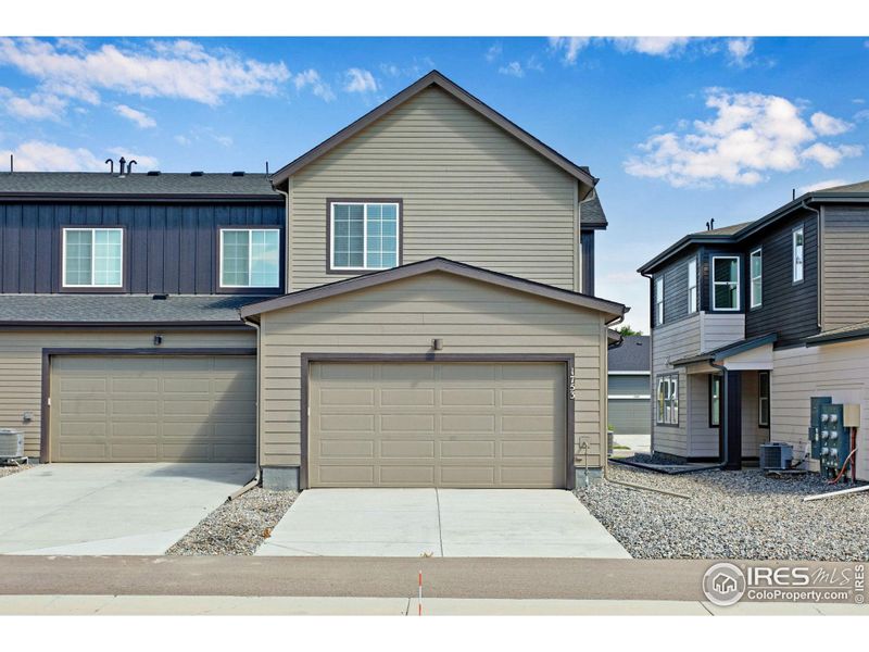 Front exterior of a new home in Westside Crossing Townhomes, Berthoud, CO, highlighting curb appeal (Image 24).