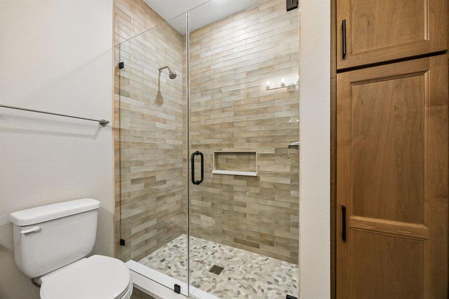 Bathroom with toilet and a shower stall Bathroom with toilet and a shower stall