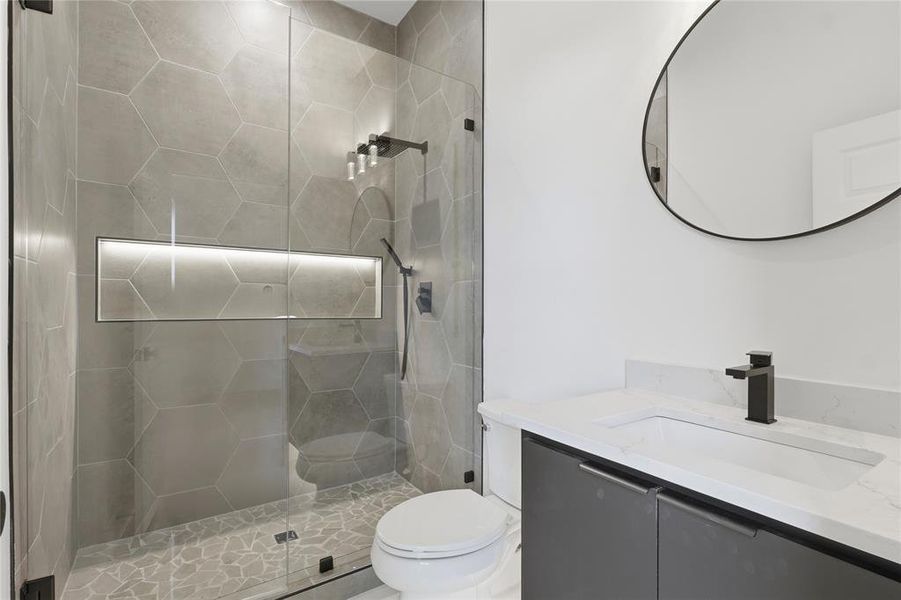 Bathroom featuring vanity and a stall shower Bathroom featuring vanity and a stall shower