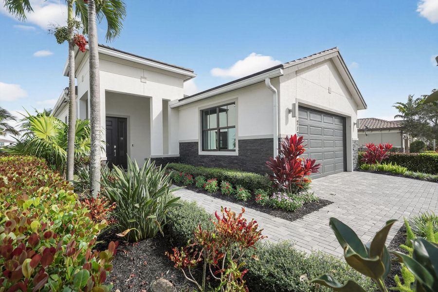 Front exterior of a new home in Tesoro Club, Port St. Lucie, FL, highlighting curb appeal (Image 21). Front exterior of a new home in Tesoro Club, Port St. Lucie, FL, highlighting curb appeal (Image 21).