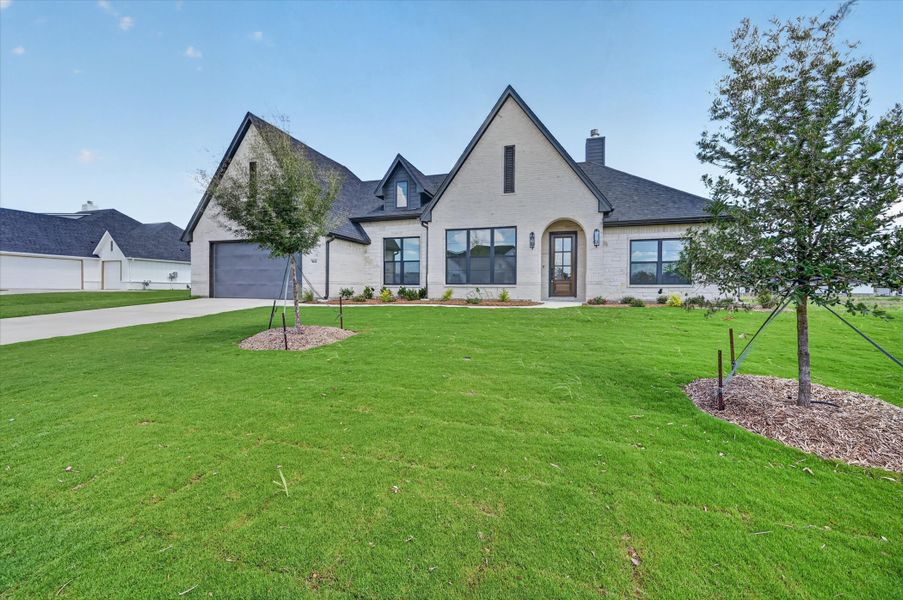 Front exterior of a new home in Paloma Ranches, Justin, TX, highlighting curb appeal (Image 23).
