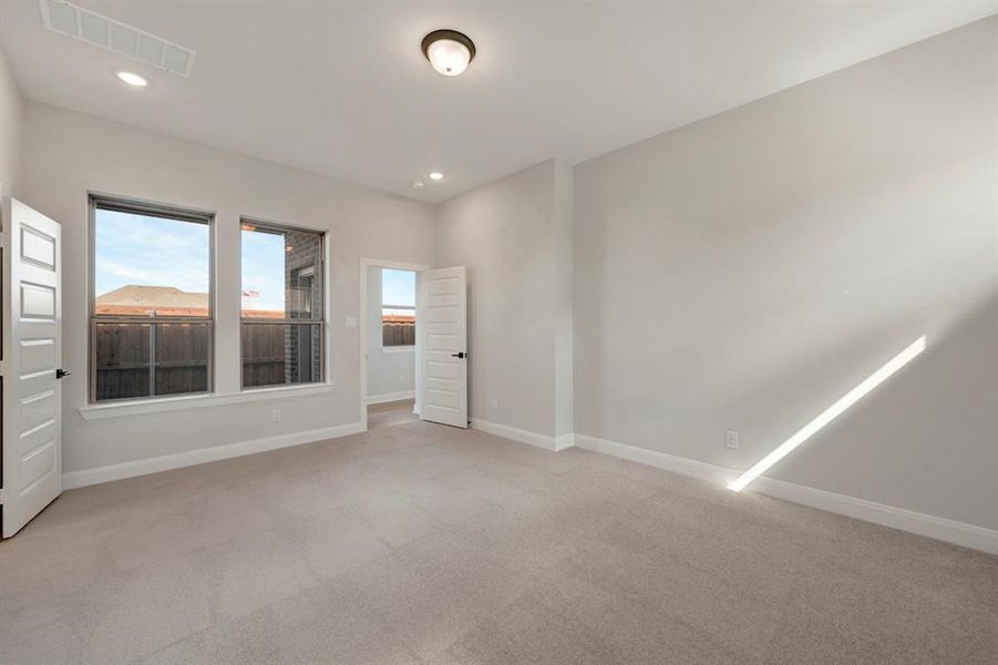 Unfurnished room featuring light carpet and recessed lighting