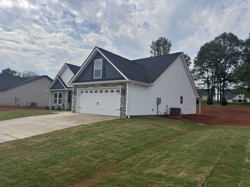 Front exterior of a new home in Ballentine Ridge, Lyman, SC, highlighting curb appeal (Image 2).